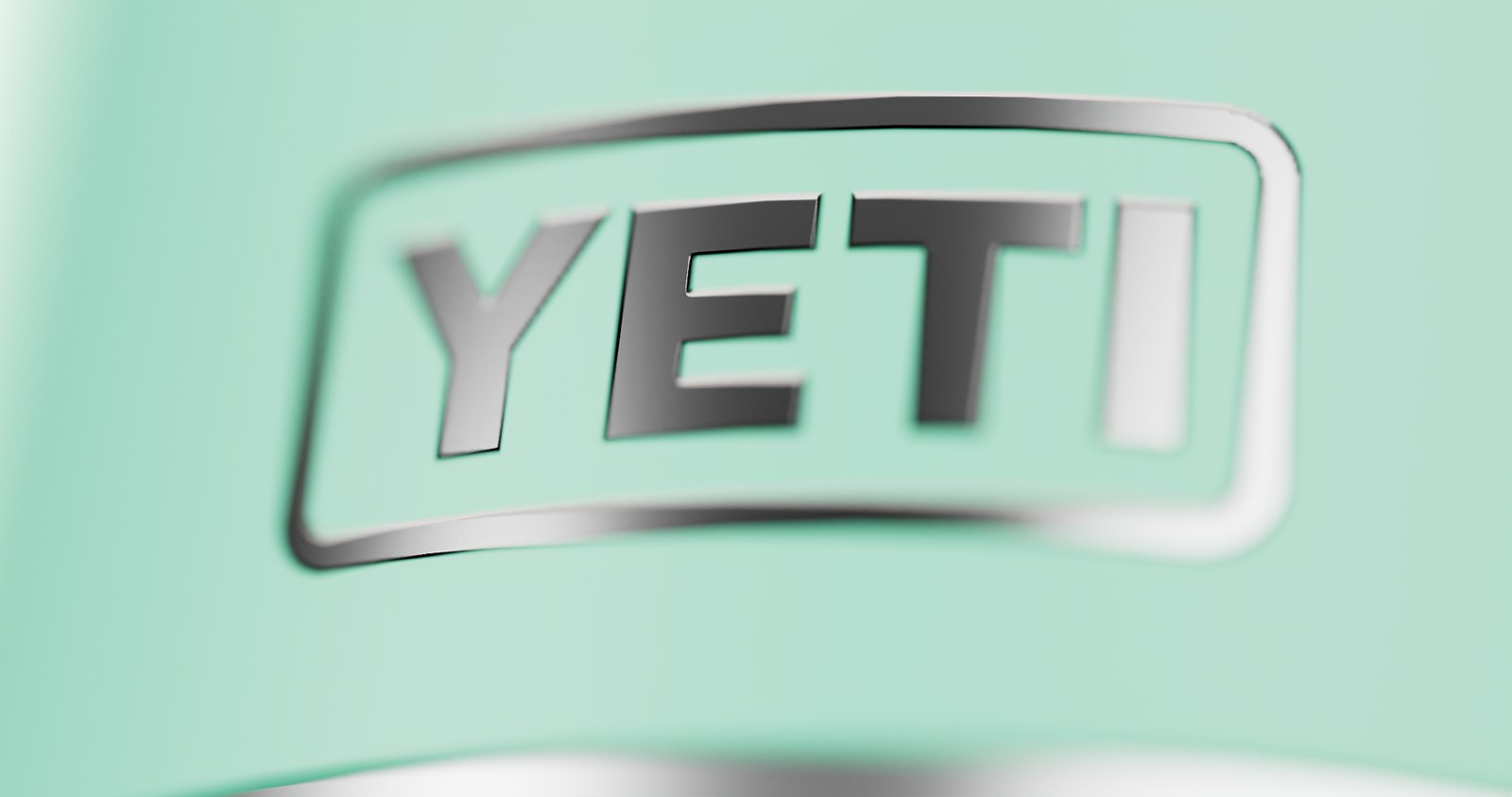 Macro of the embossed YETI logo on seafoam green