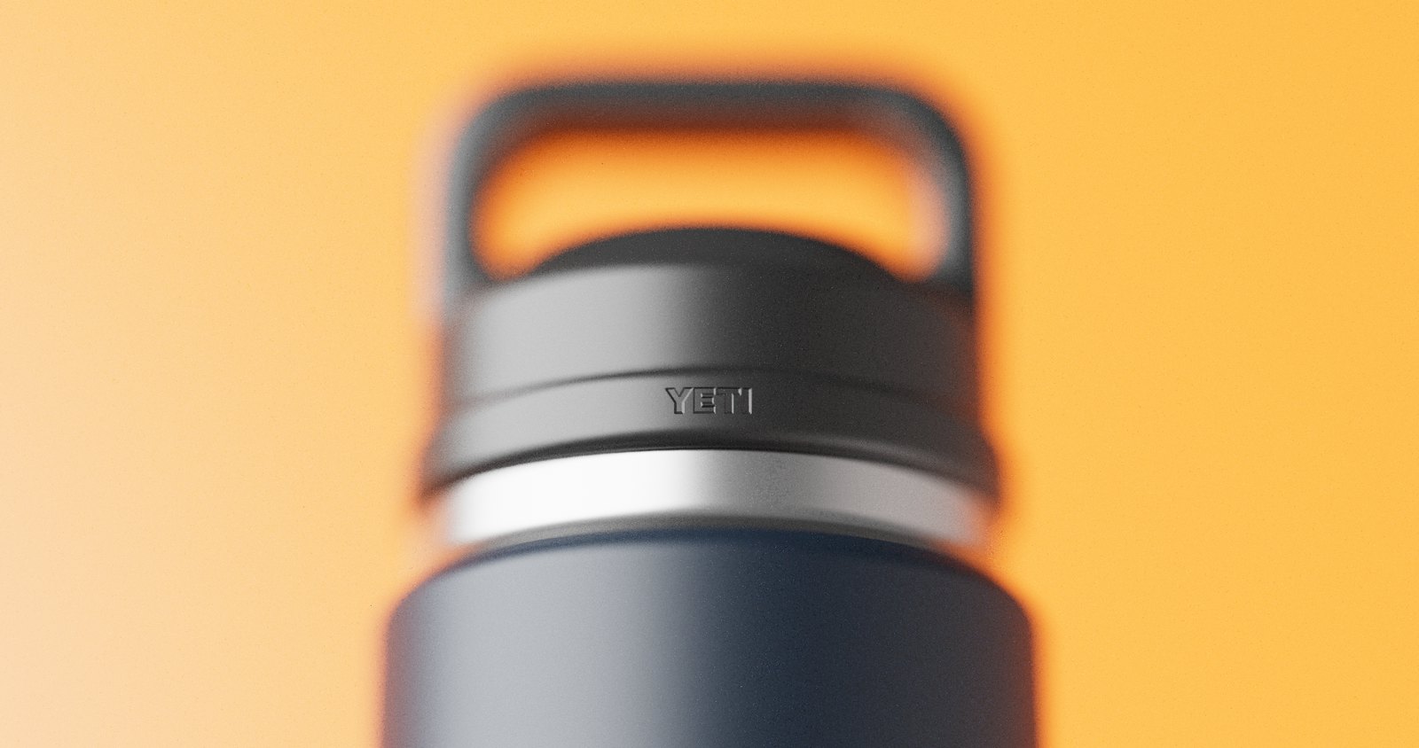 Macro of the YETI chug cap against warm orange